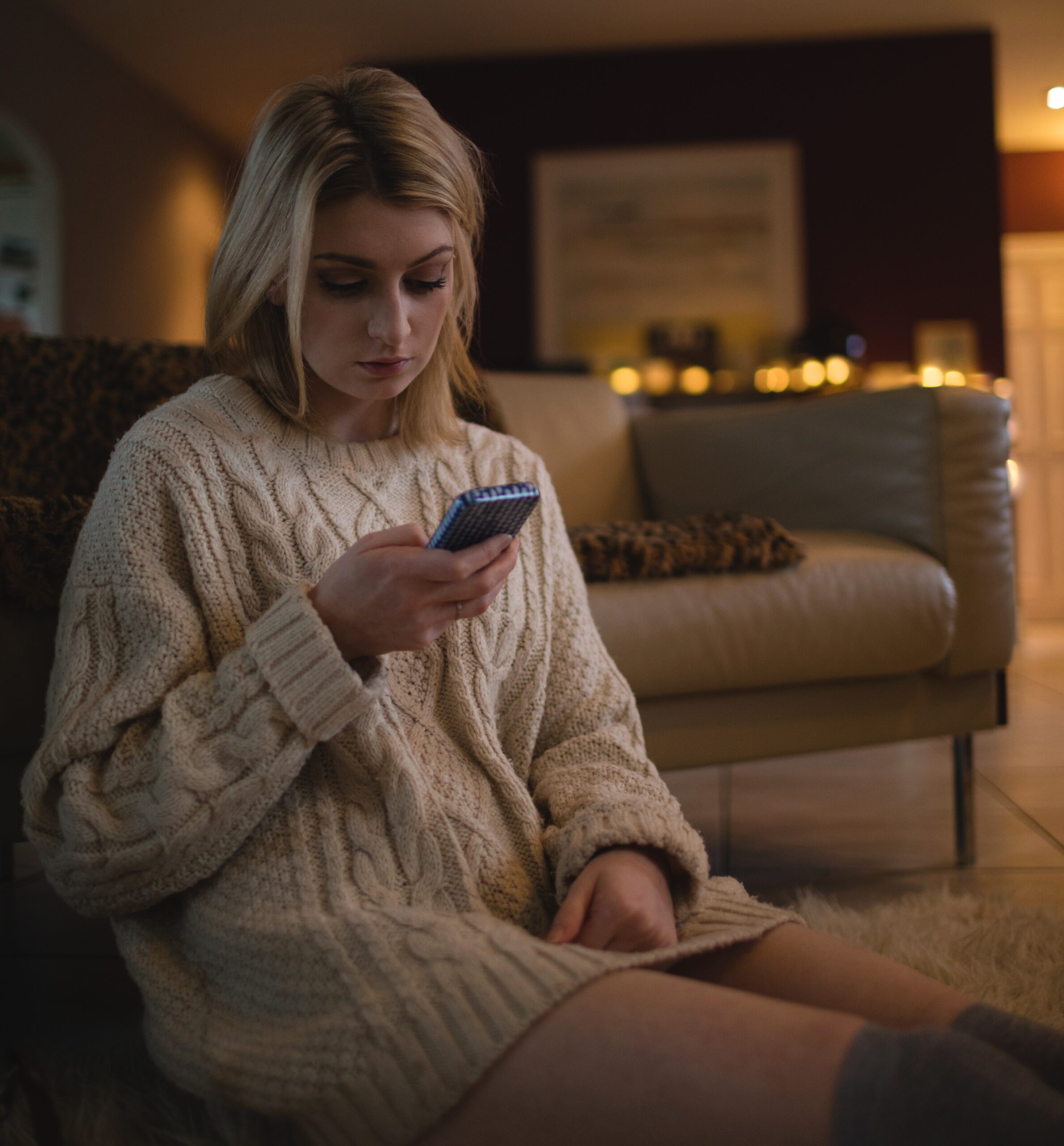 Frau sitzt nachdenklich in Innenraum